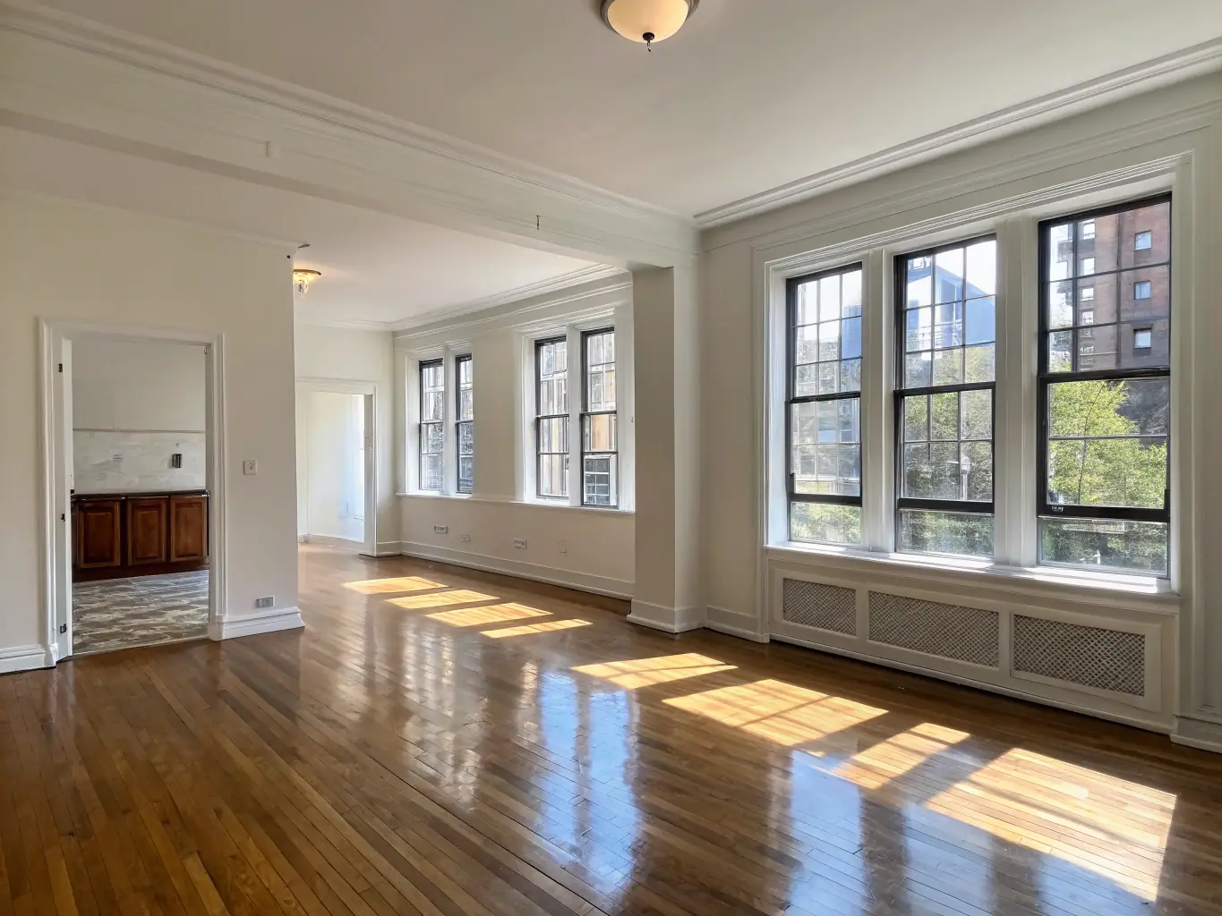 A photograph of an empty apartment, freshly cleaned and ready for new tenants, showcasing the cleanliness of the floors and windows.
